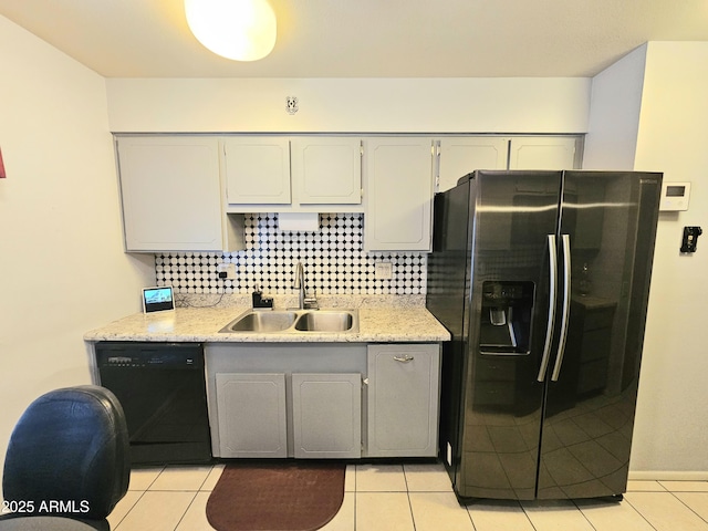 kitchen featuring sink, gray cabinetry, black dishwasher, stainless steel refrigerator with ice dispenser, and decorative backsplash