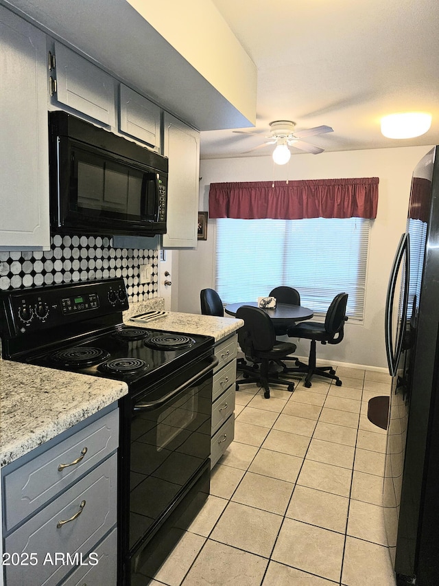 kitchen featuring gray cabinets, white cabinetry, backsplash, light tile patterned floors, and black appliances