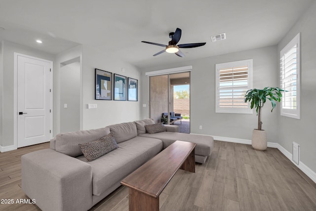 31435 N 130th Ave, Peoria, AZ 85383 - living area featuring wood finished floors, visible vents, a ceiling fan, and baseboards