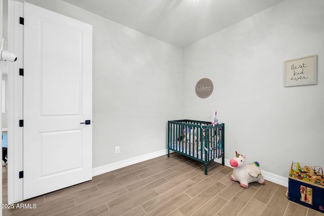 31435 N 130th Ave, Peoria, AZ 85383 - unfurnished bedroom with a crib, wood finished floors, and baseboards