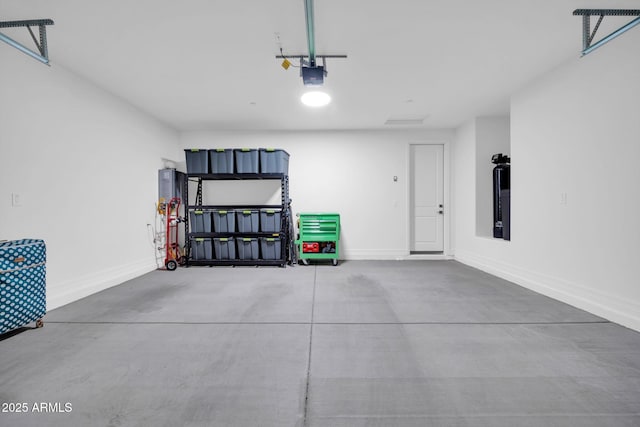 31435 N 130th Ave, Peoria, AZ 85383 - garage with baseboards and a garage door opener