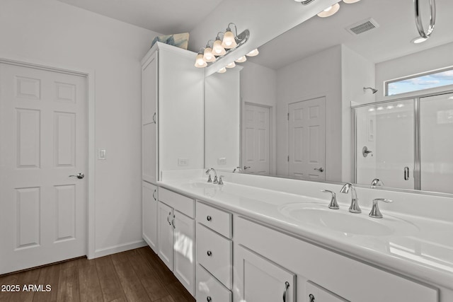 bathroom featuring vanity, a shower with shower door, and hardwood / wood-style floors