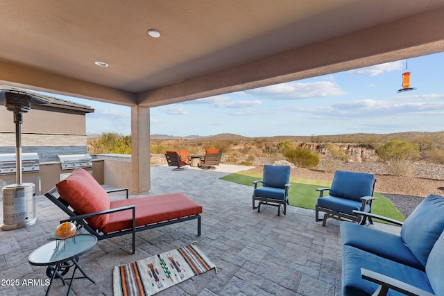 view of patio / terrace with an outdoor kitchen and a grill