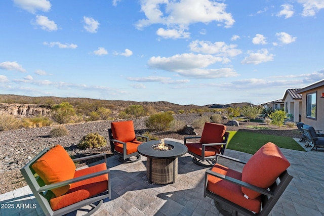 view of patio / terrace featuring a fire pit and a mountain view