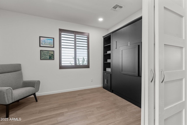 living area with light hardwood / wood-style flooring