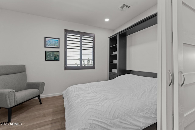 bedroom featuring hardwood / wood-style flooring and a closet