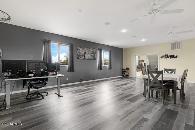 dining room with visible vents, baseboards, and wood finished floors