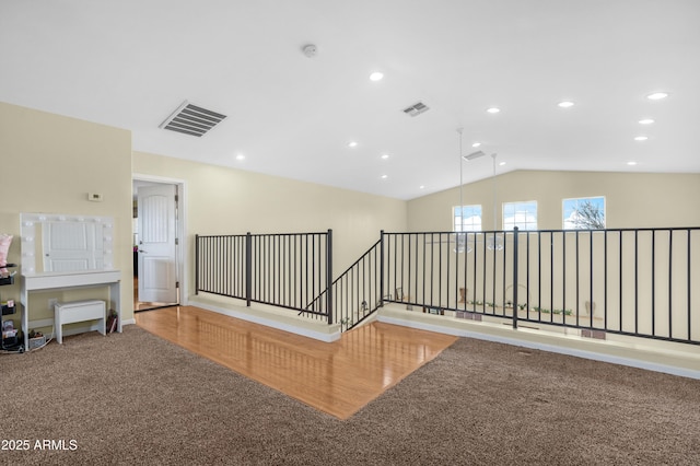 corridor featuring recessed lighting, visible vents, carpet flooring, and vaulted ceiling