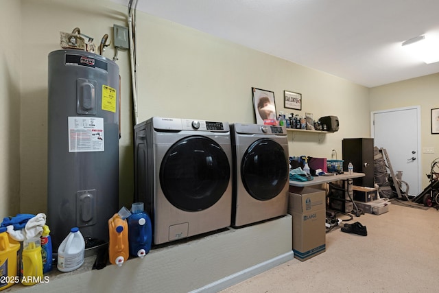 washroom with washing machine and clothes dryer, laundry area, electric water heater, and baseboards