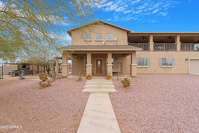 view of front of home with stucco siding, a porch, and ceiling fan