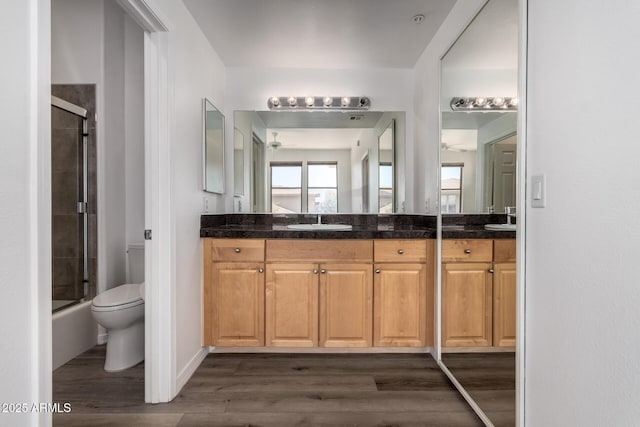19777 N 76th St Unit 2244, Scottsdale, AZ 85255 - bathroom featuring a sink, double vanity, toilet, wood finished floors, and a ceiling fan