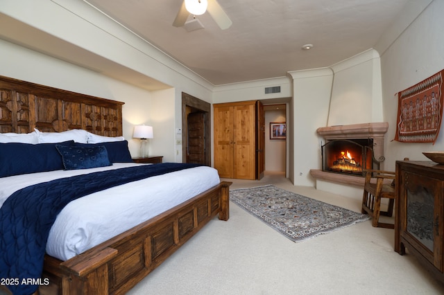 4885 N Via De La Granja, Tucson, AZ 85718 - bedroom featuring a fireplace, light colored carpet, and ceiling fan