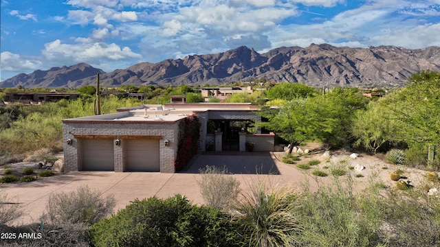 4885 N Via De La Granja, Tucson, AZ 85718 - view of front of property with brick siding, a mountain view, concrete driveway, and a garage