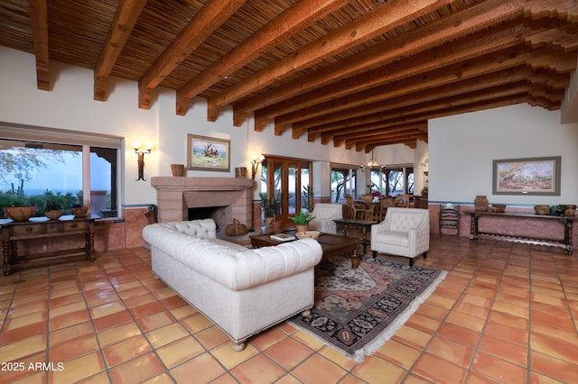 4885 N Via De La Granja, Tucson, AZ 85718 - living room with light tile patterned floors, healthy amount of natural light, wooden ceiling with exposed beams, a high end fireplace, and a chandelier