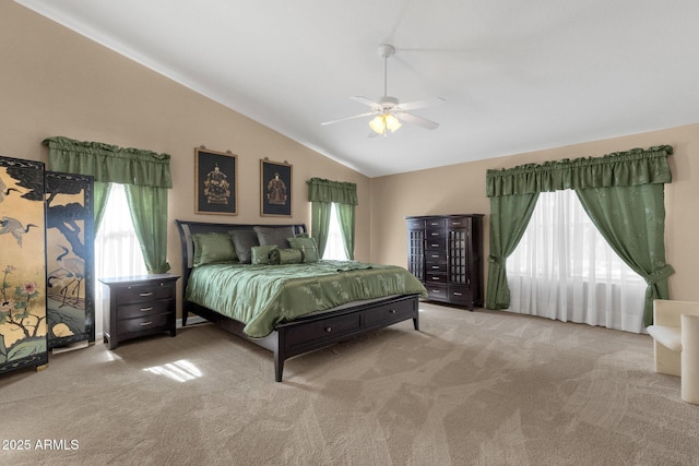 carpeted bedroom featuring multiple windows, vaulted ceiling, and ceiling fan
