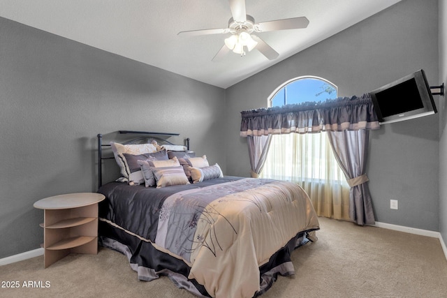bedroom with vaulted ceiling, carpet flooring, ceiling fan, and baseboards