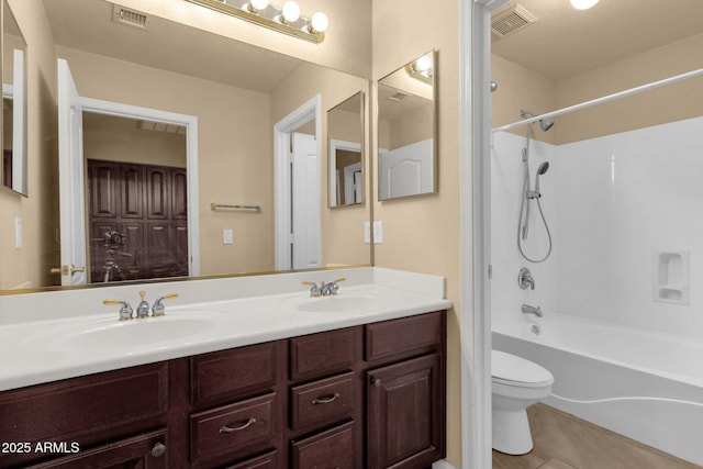 full bathroom featuring toilet, tile patterned floors, double vanity, and shower / bathtub combination