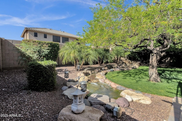 view of yard with a small pond