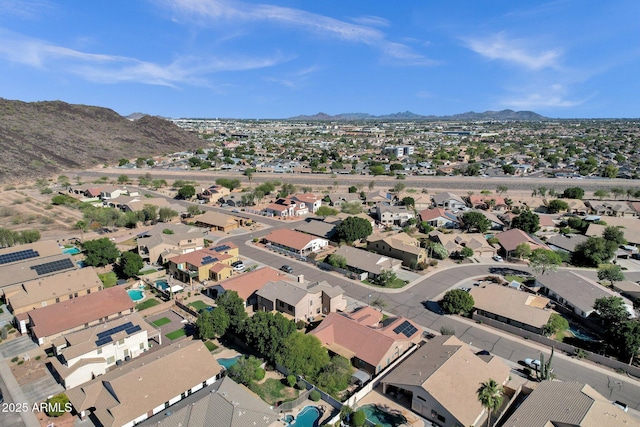 aerial view of property's location with mountains and nearby suburban area