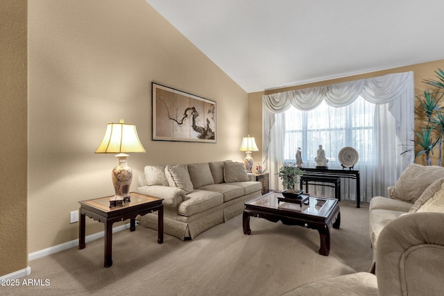 living area featuring carpet floors, baseboards, and vaulted ceiling