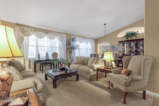 living room with light colored carpet, a chandelier, and lofted ceiling