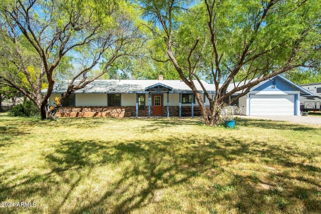 ranch-style house with a front yard and a garage