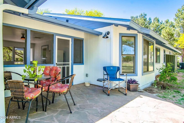 view of patio featuring a sunroom