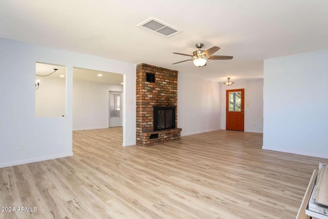 unfurnished living room with ceiling fan, light hardwood / wood-style floors, and a fireplace