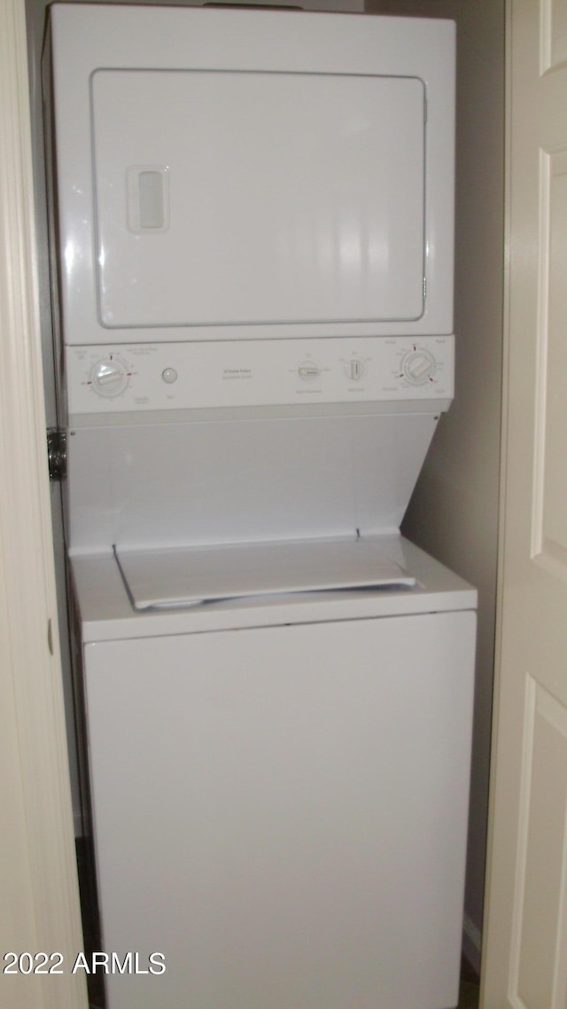 laundry area featuring laundry area and stacked washer and clothes dryer