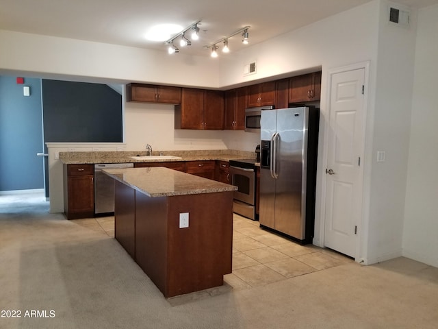 kitchen with a sink, visible vents, appliances with stainless steel finishes, and a center island