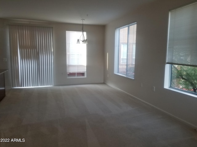 carpeted spare room with baseboards