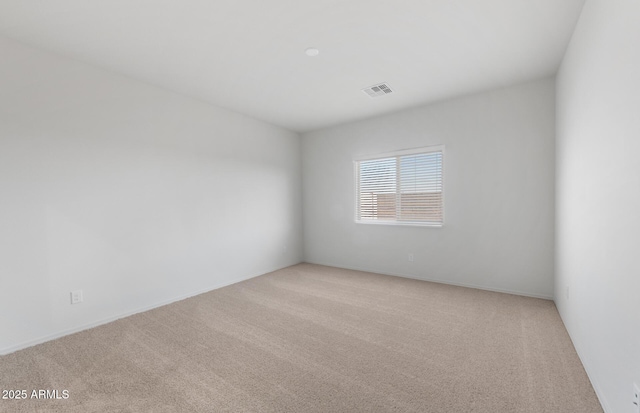 empty room featuring light carpet and visible vents