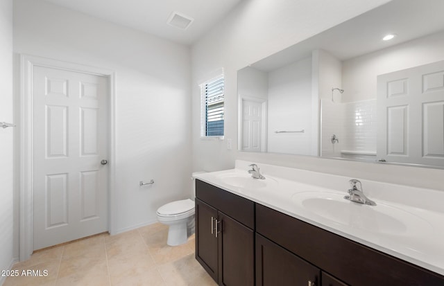 bathroom featuring tile patterned flooring, a sink, toilet, and walk in shower