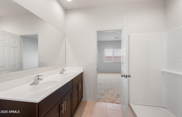 bathroom with double vanity, a sink, and tile patterned floors