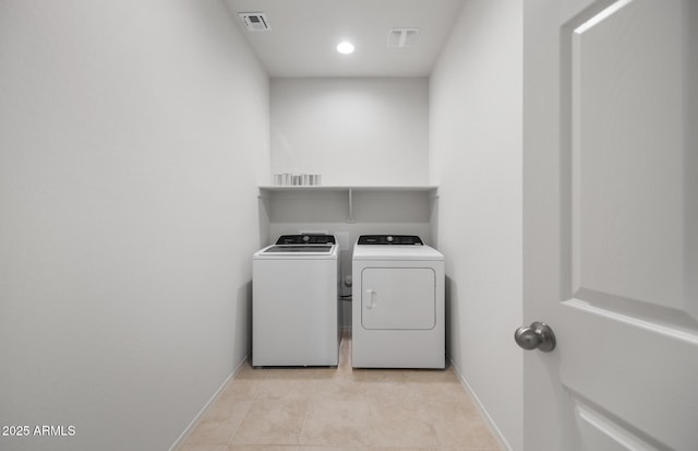 laundry room featuring laundry area, baseboards, visible vents, separate washer and dryer, and light tile patterned flooring