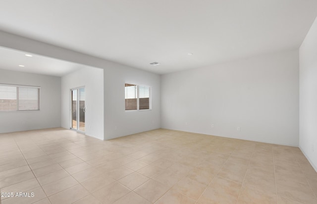 empty room featuring light tile patterned floors and visible vents