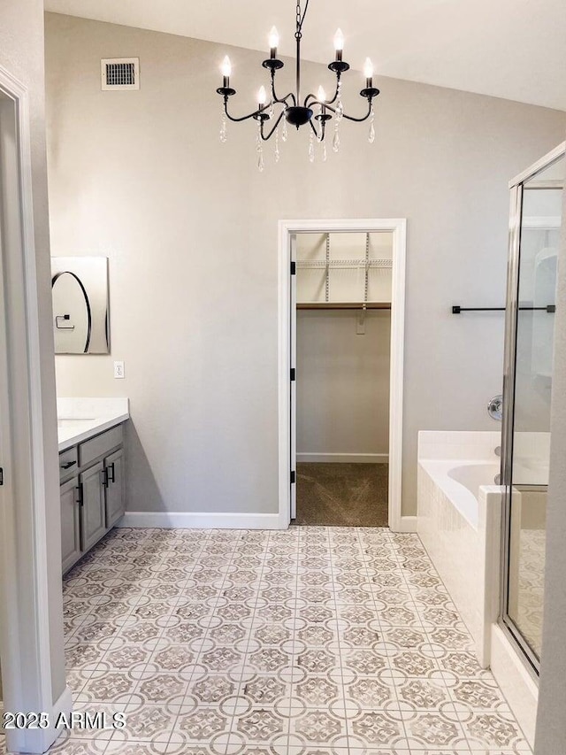 40618 N Apollo Way, Anthem, AZ 85086 - full bathroom featuring a garden tub, a shower stall, vanity, a chandelier, and a walk in closet