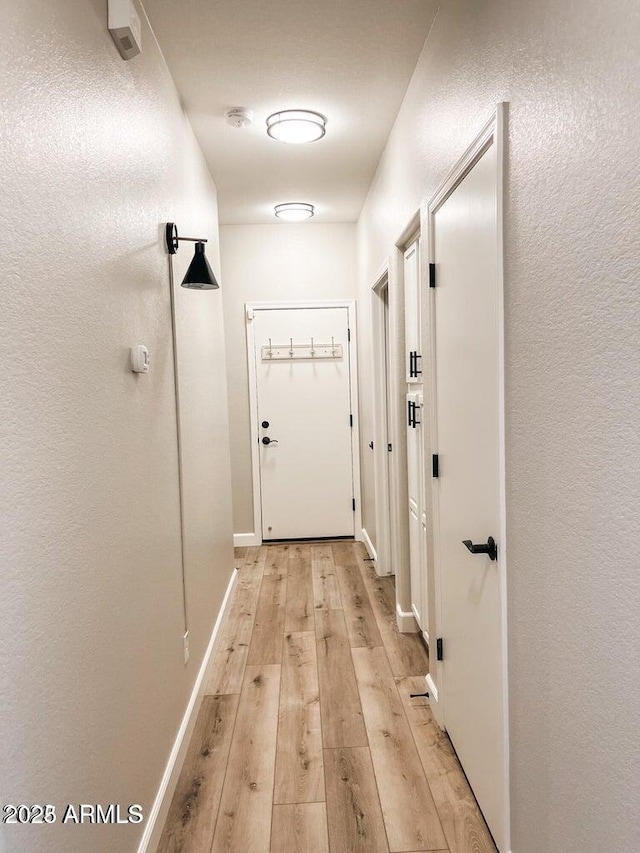 40618 N Apollo Way, Anthem, AZ 85086 - doorway with light wood-style floors and baseboards