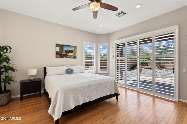 bedroom with access to outside, ceiling fan, and hardwood / wood-style flooring