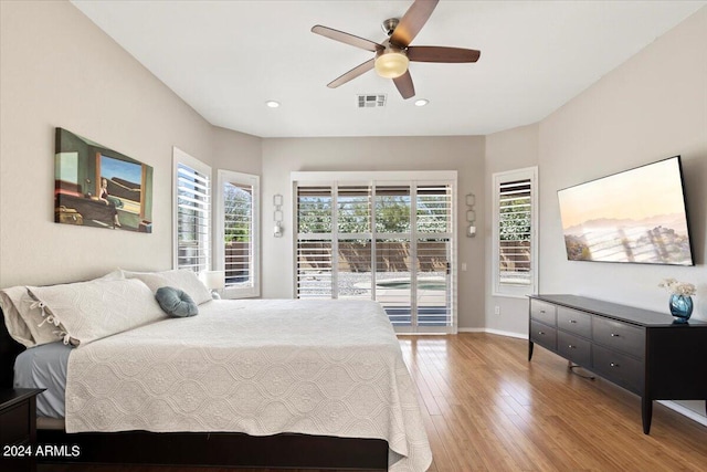 bedroom with ceiling fan, access to exterior, light wood-type flooring, and multiple windows