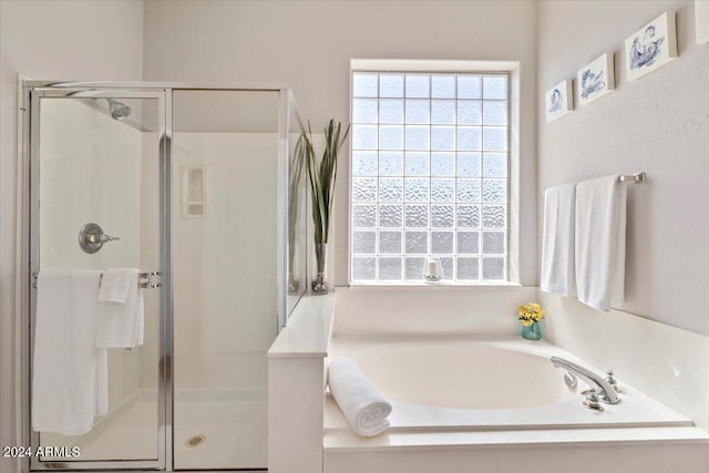 bathroom with separate shower and tub