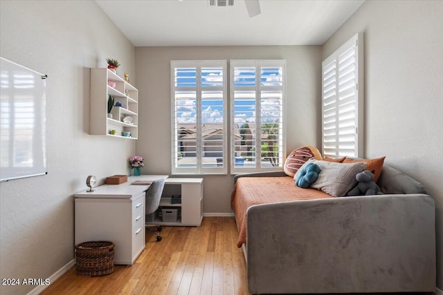 bedroom with ceiling fan and light hardwood / wood-style floors