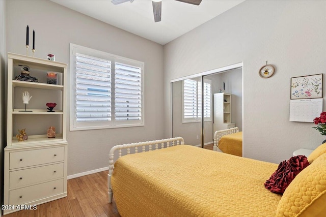 bedroom with ceiling fan, a closet, light wood-type flooring, and multiple windows