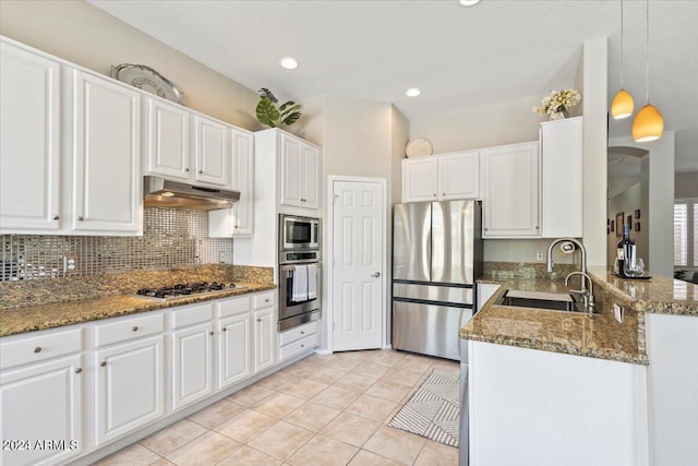 kitchen featuring white cabinetry, decorative light fixtures, and appliances with stainless steel finishes