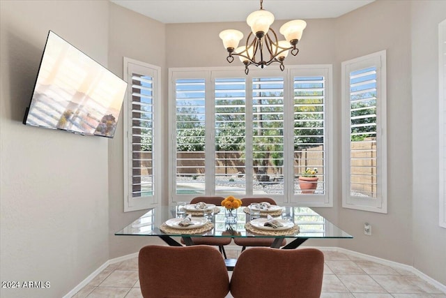 dining space featuring a wealth of natural light, a notable chandelier, and light tile patterned flooring