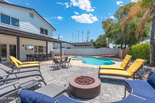 view of pool featuring a patio area, a fenced in pool, french doors, and a fenced backyard