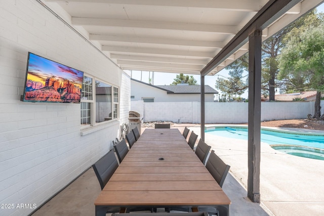 view of patio with a swimming pool with hot tub