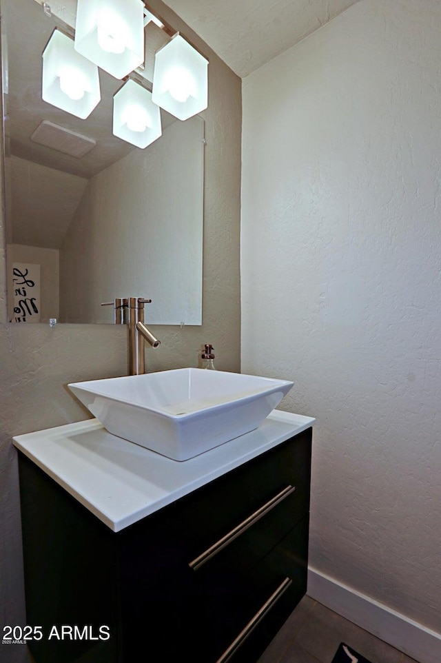 4600 N 68th St Unit 351, Scottsdale, AZ 85251 - bathroom featuring vanity, a textured wall, and lofted ceiling
