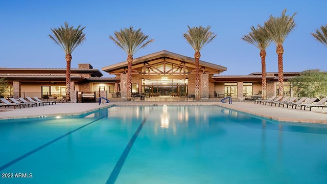 pool with a patio and fence