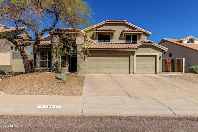 16047 S 14th Dr, Phoenix, AZ 85045 - mediterranean / spanish-style house featuring a tiled roof, a garage, concrete driveway, and stucco siding